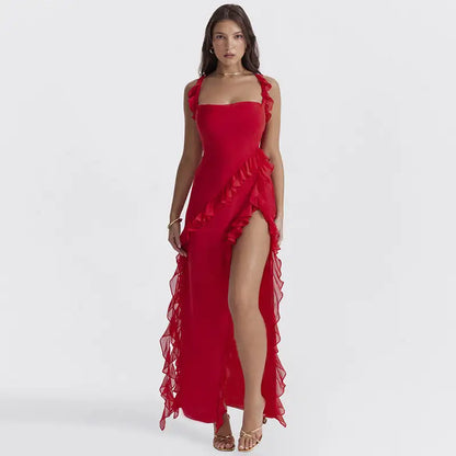 Model wearing a stylish red Aurora Maxi Dress with ruffle details and a thigh-high slit.